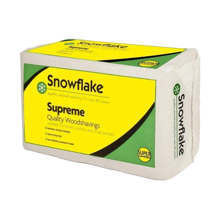 A package of Snowflake Supreme Quality Woodshavings, featuring a white block of woodshavings wrapped in paper with a bright yellow and green label.